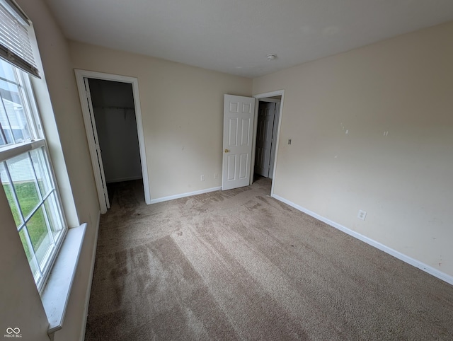 10722 Mistflower Way, Indianapolis, IN 46235 - unfurnished bedroom with carpet floors, a spacious closet, baseboards, and a closet