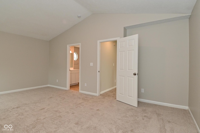 10722 Mistflower Way, Indianapolis, IN 46235 - unfurnished bedroom with lofted ceiling, light colored carpet, and ensuite bath