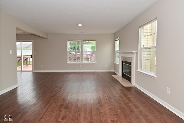 10722 Mistflower Way, Indianapolis, IN 46235 - unfurnished living room with dark wood-style floors and a tile fireplace