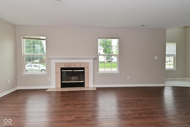 10722 Mistflower Way, Indianapolis, IN 46235 - unfurnished living room featuring wood finished floors, healthy amount of natural light, and a fireplace