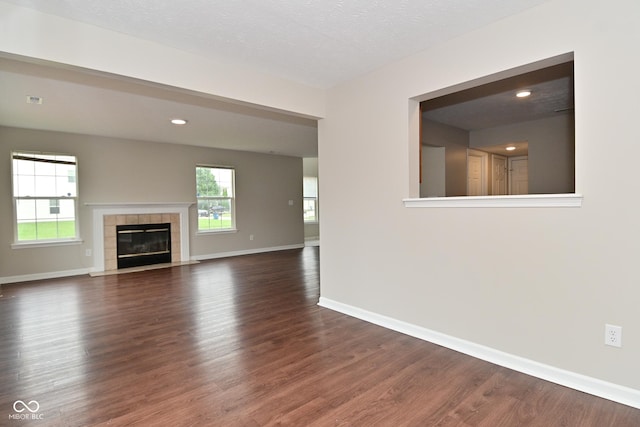 10722 Mistflower Way, Indianapolis, IN 46235 - unfurnished living room with wood finished floors and a tiled fireplace