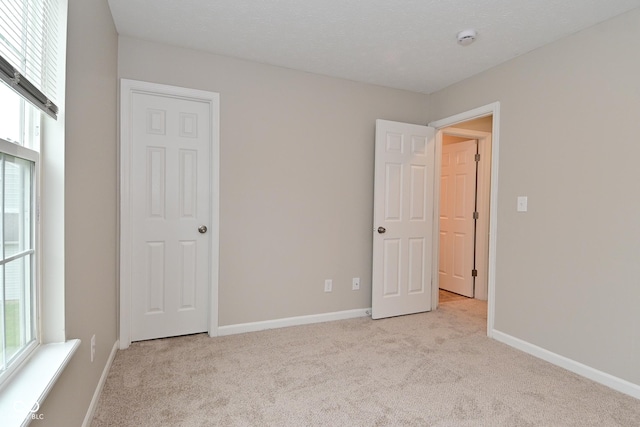 10722 Mistflower Way, Indianapolis, IN 46235 - unfurnished bedroom featuring light carpet and multiple windows