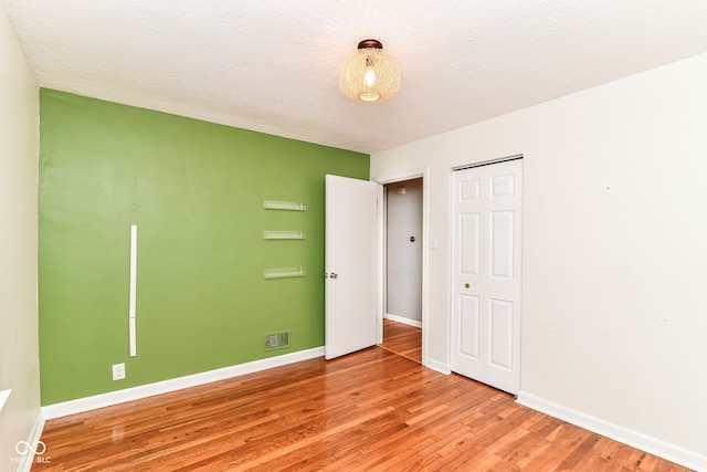 2526 Dell Zell Dr, Indianapolis, IN 46220 - unfurnished bedroom featuring light wood-type flooring, baseboards, and a closet