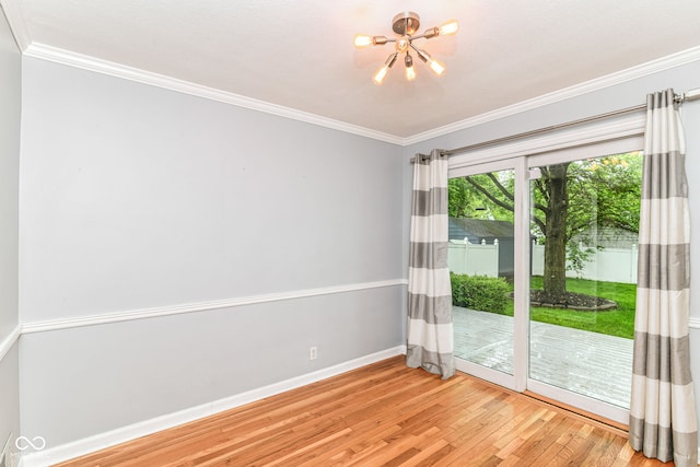 2526 Dell Zell Dr, Indianapolis, IN 46220 - spare room featuring a chandelier, light wood-type flooring, baseboards, and crown molding
