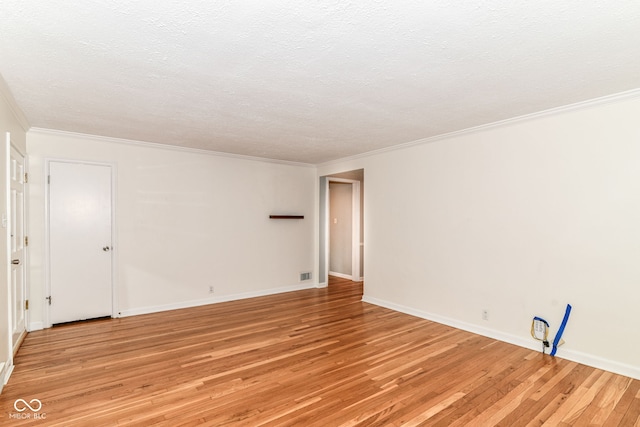 2526 Dell Zell Dr, Indianapolis, IN 46220 - spare room featuring light wood finished floors, crown molding, baseboards, and a textured ceiling