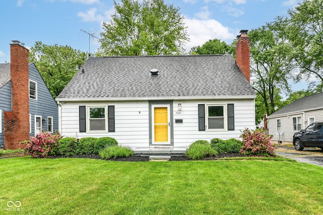 2526 Dell Zell Dr, Indianapolis, IN 46220 - cape cod-style house with a front yard, roof with shingles, and a chimney