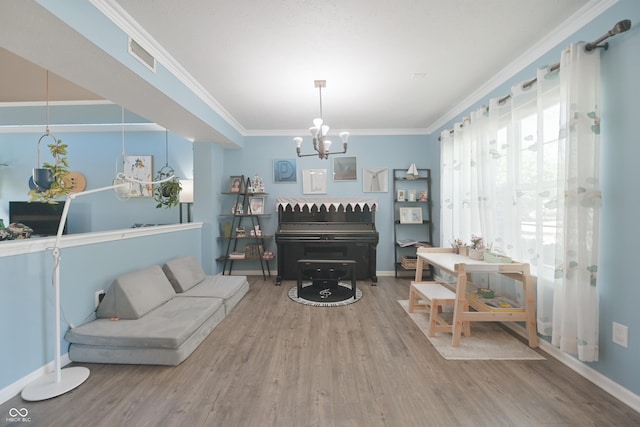 12677 Honors Dr, Carmel, IN 46033 - living area with wood finished floors, a chandelier, ornamental molding, and baseboards