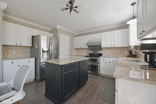 12677 Honors Dr, Carmel, IN 46033 - kitchen featuring appliances with stainless steel finishes, a sink, ornamental molding, white cabinets, and a center island