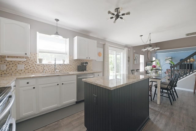 12677 Honors Dr, Carmel, IN 46033 - kitchen featuring appliances with stainless steel finishes, a sink, wood finished floors, and backsplash