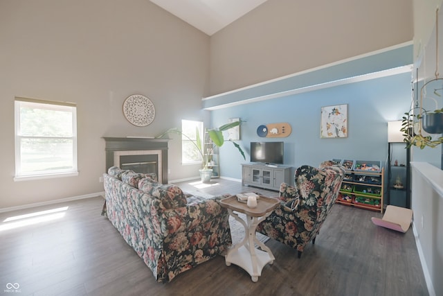 12677 Honors Dr, Carmel, IN 46033 - living room featuring high vaulted ceiling, wood finished floors, baseboards, and a tile fireplace
