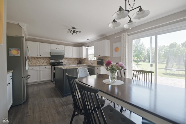 12677 Honors Dr, Carmel, IN 46033 - dining room with crown molding, dark wood finished floors, and a chandelier