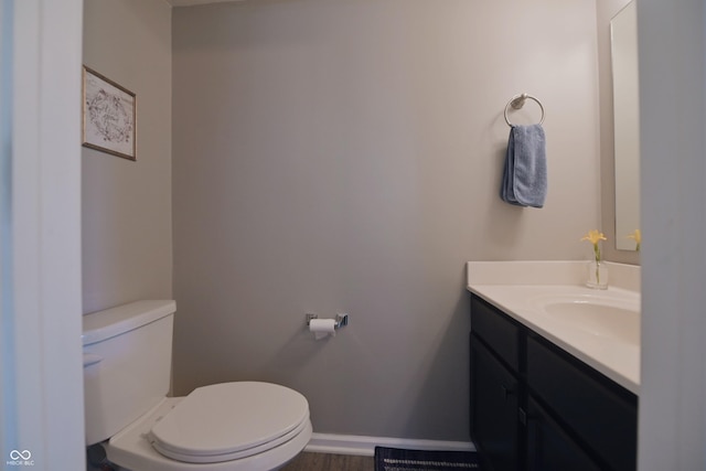 12677 Honors Dr, Carmel, IN 46033 - bathroom featuring toilet, vanity, baseboards, and wood finished floors