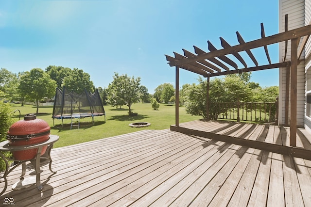 12677 Honors Dr, Carmel, IN 46033 - wooden deck featuring a fire pit, a trampoline, a yard, and a pergola