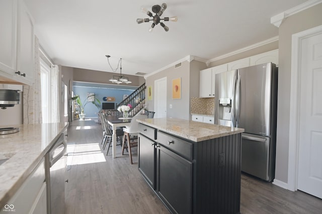 12677 Honors Dr, Carmel, IN 46033 - kitchen with appliances with stainless steel finishes, white cabinetry, decorative backsplash, dark wood-type flooring, and crown molding