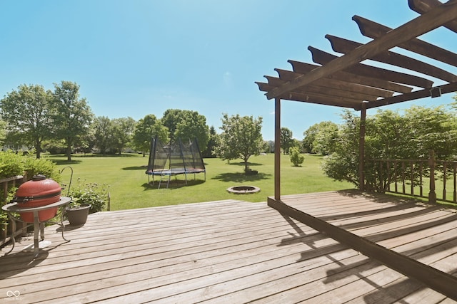 12677 Honors Dr, Carmel, IN 46033 - deck with a trampoline, a fire pit, a lawn, a pergola, and view of scattered trees