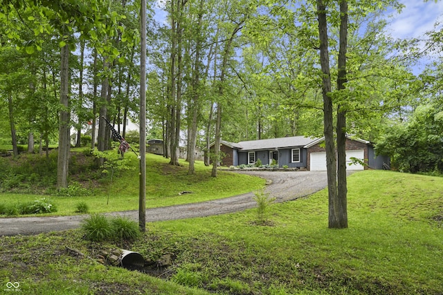 1673 W Shady Ln, Greensburg, IN 47240 - view of front facade featuring driveway, a front yard, and a garage