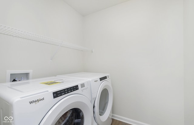 9741 Oleander Dr, Fishers, IN 46250 - washroom featuring independent washer and dryer, baseboards, and wood finished floors