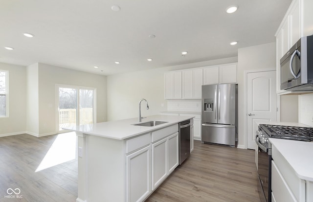 9741 Oleander Dr, Fishers, IN 46250 - kitchen featuring stainless steel appliances, a sink, white cabinets, recessed lighting, and light countertops