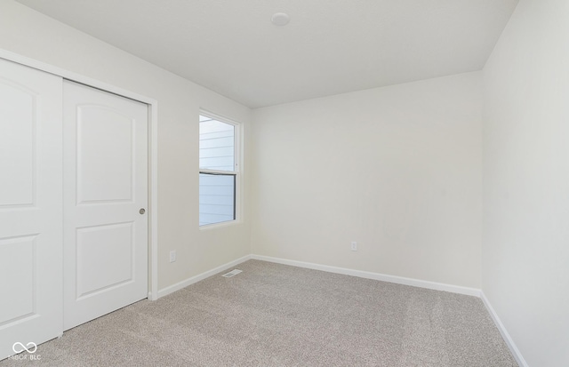 9741 Oleander Dr, Fishers, IN 46250 - unfurnished bedroom with light colored carpet, baseboards, and a closet