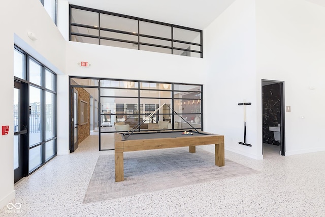 9741 Oleander Dr, Fishers, IN 46250 - recreation room featuring speckled floor, a towering ceiling, baseboards, and billiards