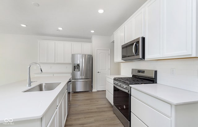 9741 Oleander Dr, Fishers, IN 46250 - kitchen with appliances with stainless steel finishes, a sink, backsplash, white cabinets, and recessed lighting