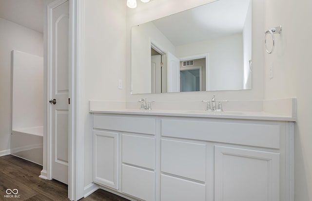 9741 Oleander Dr, Fishers, IN 46250 - full bath with double vanity, wood finished floors, and a tub to relax in
