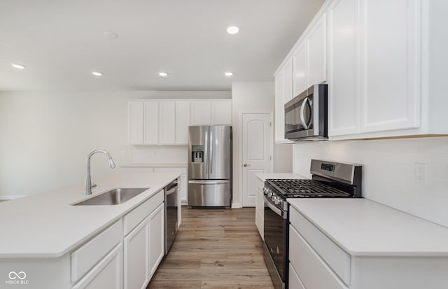 9741 Oleander Dr, Fishers, IN 46250 - kitchen with appliances with stainless steel finishes, recessed lighting, light wood-style floors, white cabinetry, and light countertops