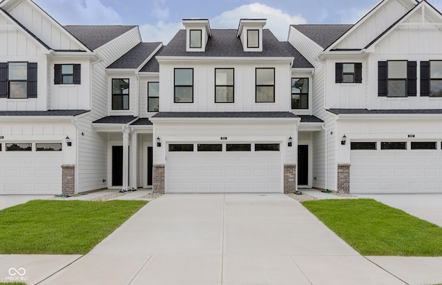 9741 Oleander Dr, Fishers, IN 46250 - townhome / multi-family property featuring board and batten siding, a garage, driveway, and brick siding