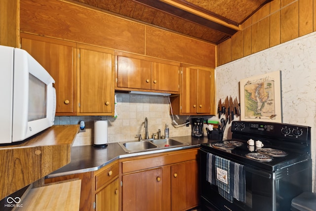 8434 S Christian Dr, Nineveh, IN 46164 - kitchen with black electric range, white microwave, a sink, backsplash, and brown cabinetry