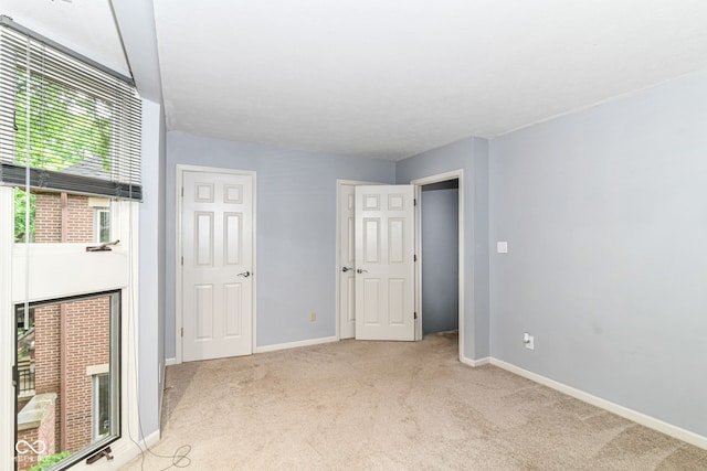 558 E Vermont St, Indianapolis, IN 46202 - unfurnished bedroom featuring light colored carpet and baseboards