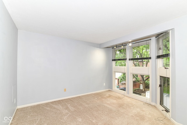 558 E Vermont St, Indianapolis, IN 46202 - spare room featuring light colored carpet and baseboards