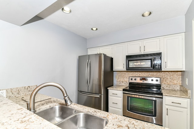 558 E Vermont St, Indianapolis, IN 46202 - kitchen with appliances with stainless steel finishes, a sink, decorative backsplash, white cabinetry, and recessed lighting
