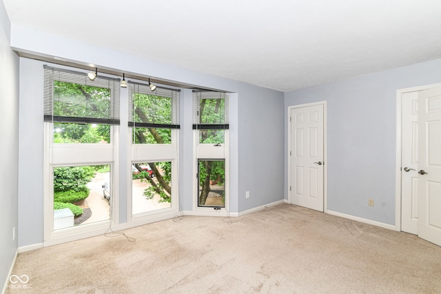 558 E Vermont St, Indianapolis, IN 46202 - unfurnished room featuring plenty of natural light, carpet floors, and baseboards