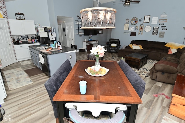 7515 Brattle Dr, Indianapolis, IN 46113 - dining room featuring light wood-type flooring, a ceiling fan, and a high ceiling