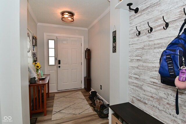 7515 Brattle Dr, Indianapolis, IN 46113 - foyer entrance with wood finished floors, wooden walls, crown molding, and an accent wall