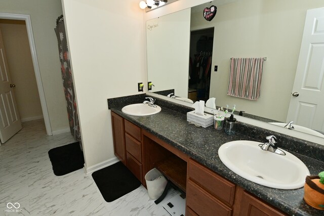 7515 Brattle Dr, Indianapolis, IN 46113 - bathroom featuring double vanity and baseboards