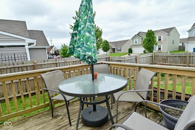 7515 Brattle Dr, Indianapolis, IN 46113 - wooden terrace with outdoor dining space, a residential view, and a fenced backyard