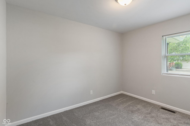 1002 Collier St, Indianapolis, IN 46241 - empty room featuring dark colored carpet and baseboards