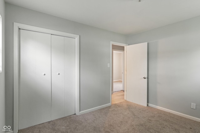 1002 Collier St, Indianapolis, IN 46241 - unfurnished bedroom featuring carpet floors, baseboards, and a closet