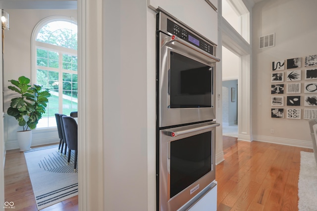 11911 W Grandview Dr, Columbus, IN 47201 - kitchen with stainless steel double oven, light wood finished floors, and baseboards