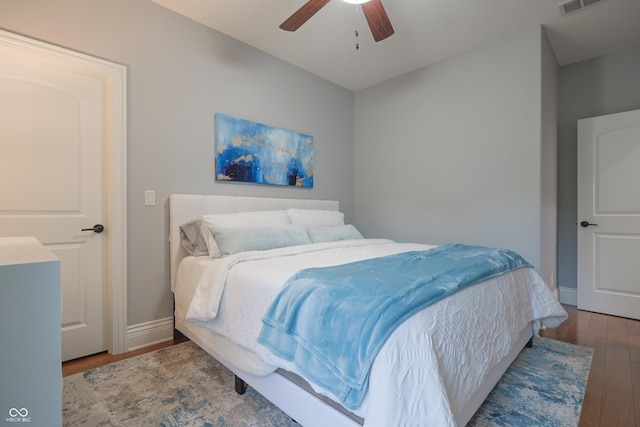 11911 W Grandview Dr, Columbus, IN 47201 - bedroom with wood finished floors, baseboards, and a ceiling fan