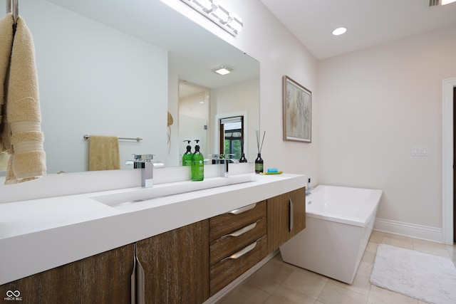 11911 W Grandview Dr, Columbus, IN 47201 - bathroom featuring vanity, a bath, tile patterned floors, recessed lighting, and baseboards