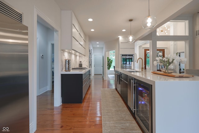 11911 W Grandview Dr, Columbus, IN 47201 - kitchen with appliances with stainless steel finishes, wine cooler, light countertops, a sink, and recessed lighting