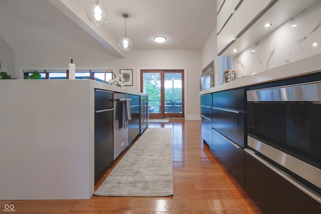 11911 W Grandview Dr, Columbus, IN 47201 - kitchen featuring light wood-style flooring, pendant lighting, and modern cabinets