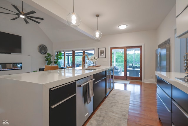 11911 W Grandview Dr, Columbus, IN 47201 - kitchen featuring a sink, stainless steel appliances, light countertops, wood finished floors, and hanging light fixtures