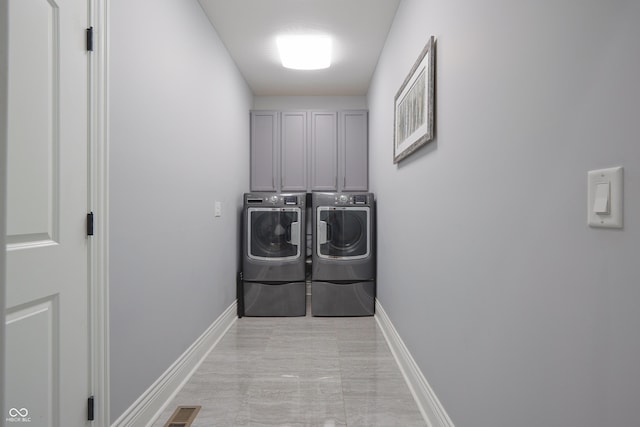 11911 W Grandview Dr, Columbus, IN 47201 - laundry area with washing machine and dryer, cabinet space, and baseboards