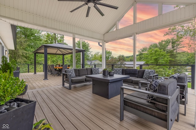 11911 W Grandview Dr, Columbus, IN 47201 - deck at dusk featuring an outdoor living space, a gazebo, a ceiling fan, and outdoor dining space
