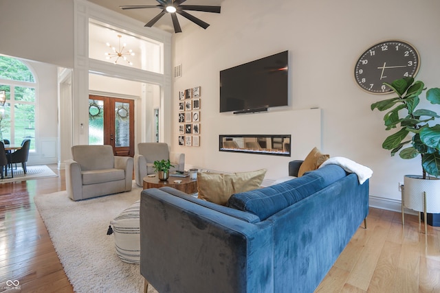 11911 W Grandview Dr, Columbus, IN 47201 - living area with french doors, hardwood / wood-style flooring, ceiling fan, and a high ceiling