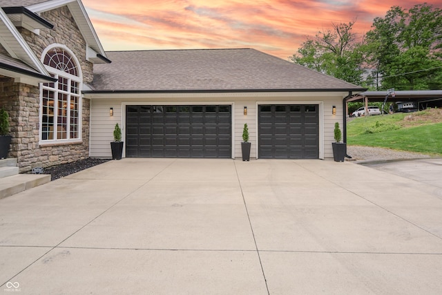 11911 W Grandview Dr, Columbus, IN 47201 - garage at dusk with concrete driveway