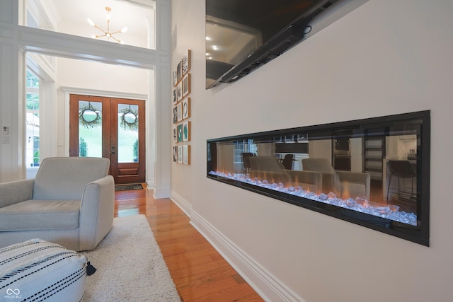 11911 W Grandview Dr, Columbus, IN 47201 - foyer entrance with wood finished floors, baseboards, french doors, and a chandelier